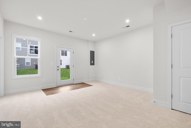 interior space featuring baseboards, visible vents, electric panel, and recessed lighting