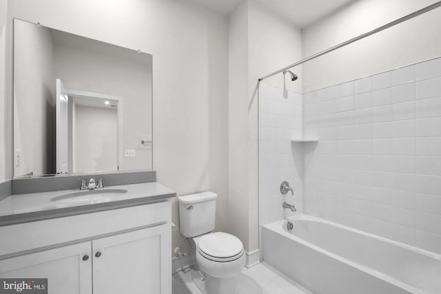 bathroom with baseboards, vanity, toilet, and bathing tub / shower combination