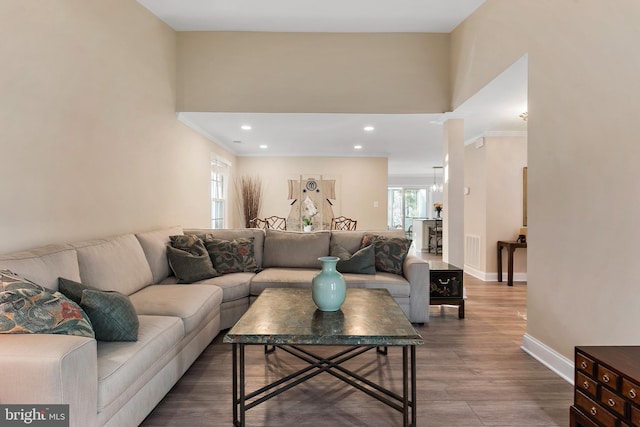 living area with visible vents, baseboards, wood finished floors, and recessed lighting