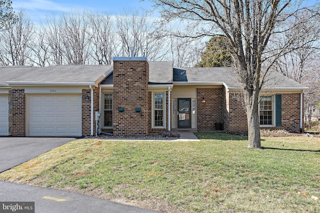 view of front of property with a garage, brick siding, and a front lawn