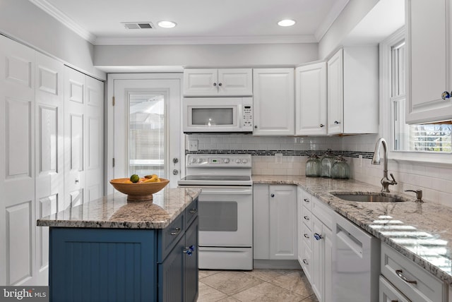 kitchen with blue cabinets, white appliances, a sink, visible vents, and white cabinets