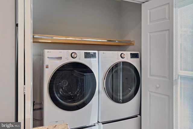 washroom featuring laundry area and washing machine and dryer