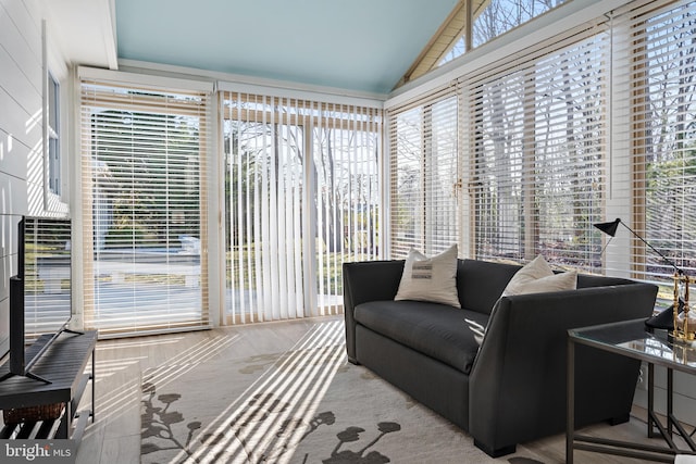 sunroom featuring vaulted ceiling