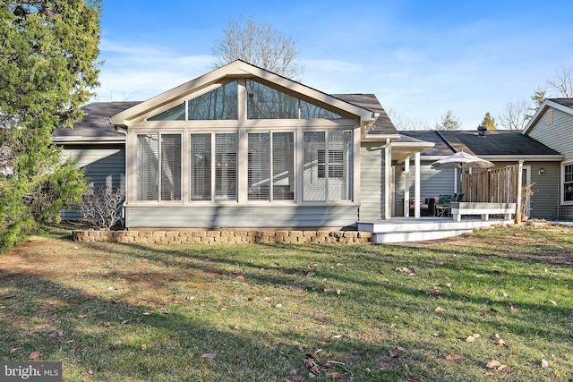 rear view of house featuring a yard