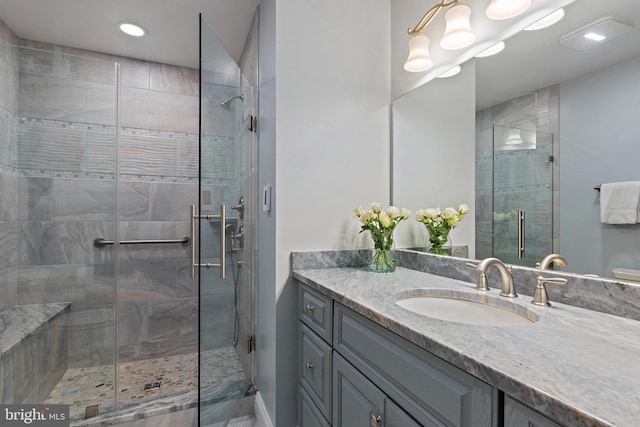 full bath featuring a stall shower and vanity