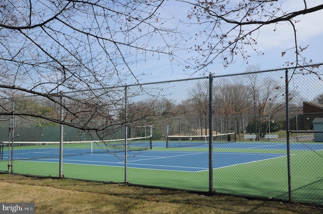 view of sport court featuring fence