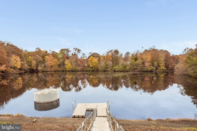 dock area with a water view and a wooded view