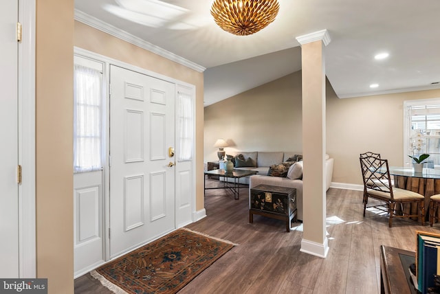 foyer with baseboards, wood finished floors, decorative columns, and crown molding