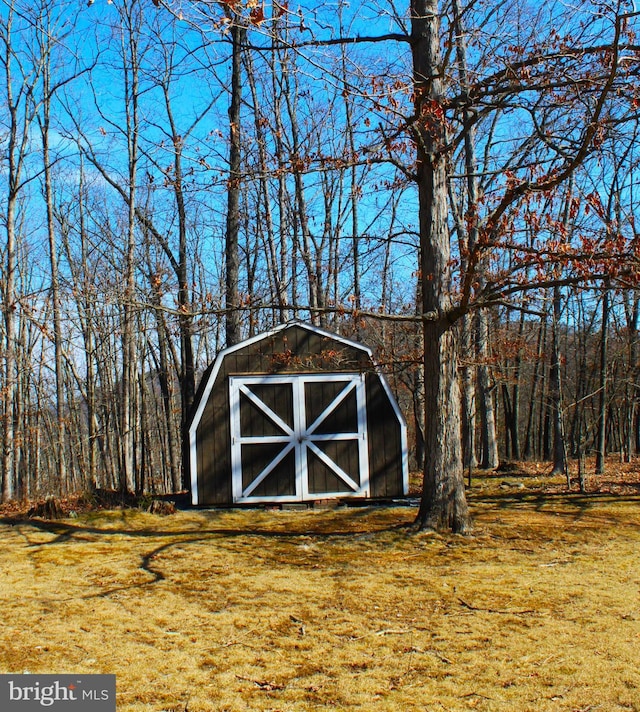 view of shed with a forest view