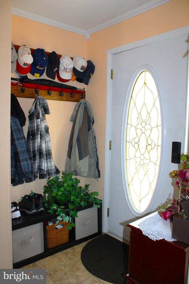 tiled foyer entrance featuring ornamental molding