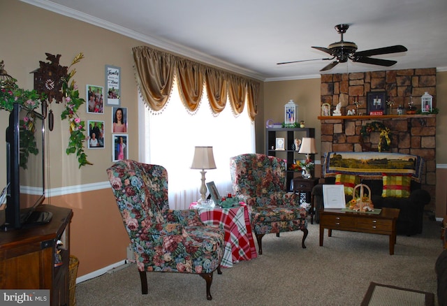 sitting room with a ceiling fan, carpet flooring, and crown molding