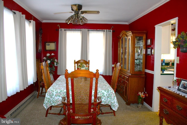 carpeted dining space featuring ornamental molding, a baseboard radiator, and a ceiling fan