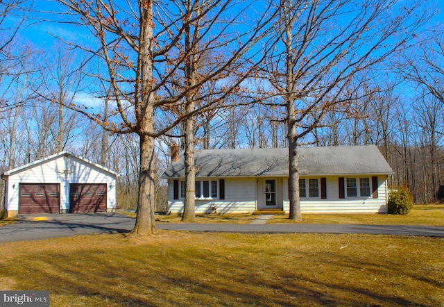 ranch-style house with a detached garage, a front lawn, and an outdoor structure