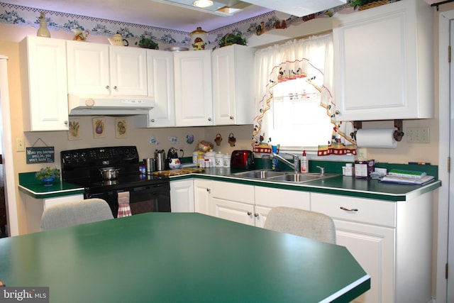 kitchen with under cabinet range hood, electric range, white cabinetry, and a sink