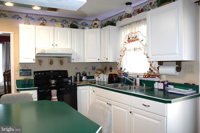 kitchen featuring under cabinet range hood, electric range, white cabinets, and a sink