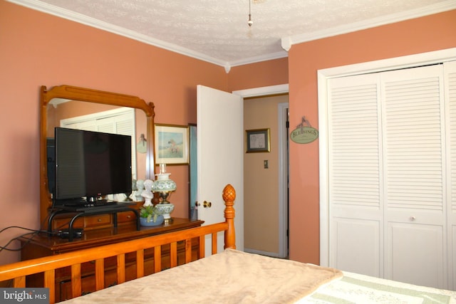 bedroom with a textured ceiling, a closet, and crown molding