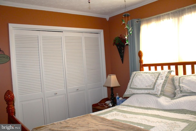 bedroom featuring ornamental molding and a closet