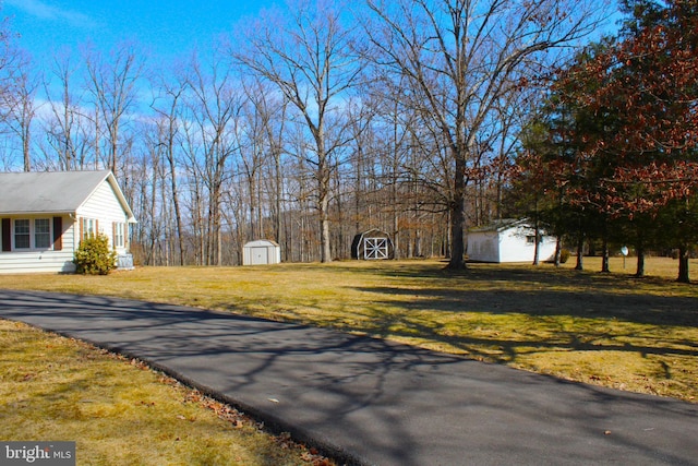 view of yard with a shed and an outbuilding