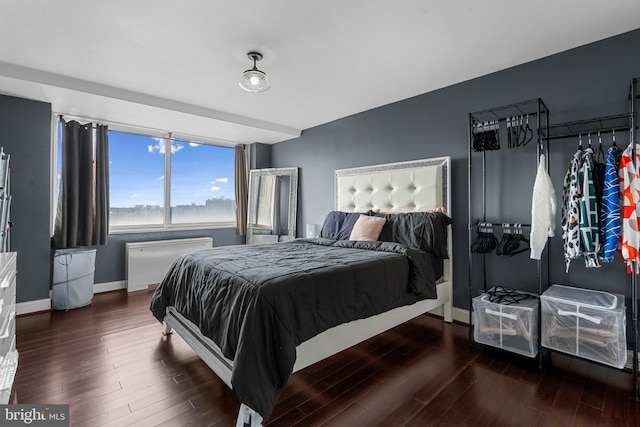 bedroom featuring baseboards and wood finished floors