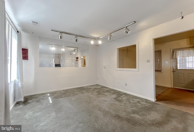 carpeted empty room with baseboards and visible vents