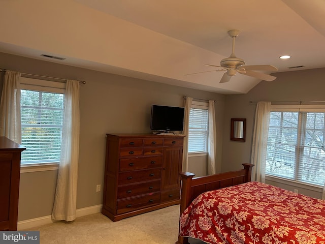 bedroom featuring light carpet, visible vents, baseboards, and vaulted ceiling