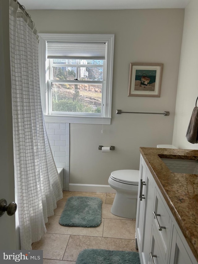 bathroom featuring tile patterned flooring, curtained shower, baseboards, toilet, and vanity