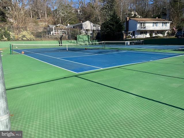 view of tennis court with fence