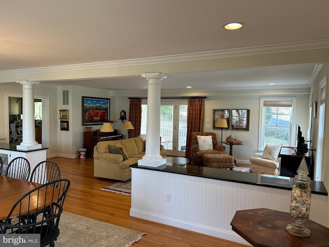 living room with ornate columns and wood finished floors