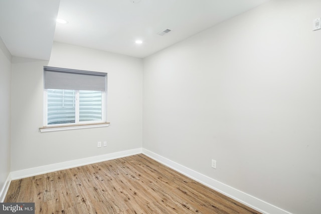 unfurnished room featuring recessed lighting, visible vents, baseboards, and wood finished floors