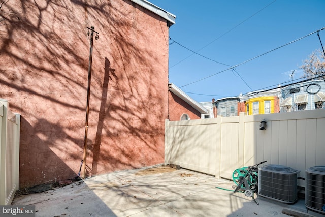 view of patio / terrace featuring central AC and fence