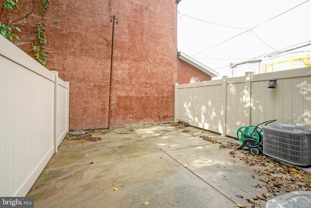 view of patio / terrace featuring central AC unit and fence