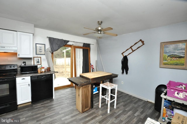 kitchen with dark wood-style floors, range hood, white cabinets, black appliances, and baseboards