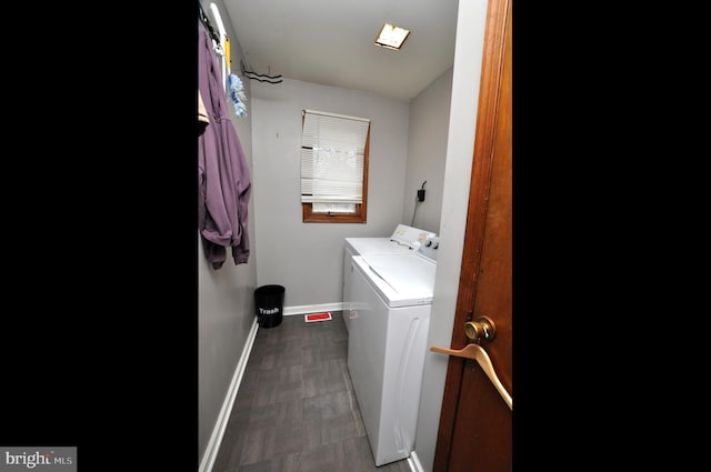 laundry room featuring laundry area, independent washer and dryer, and baseboards