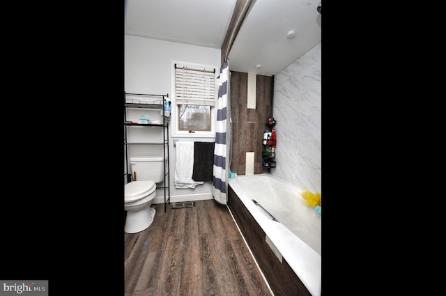 bathroom featuring shower / bath combo, toilet, and wood finished floors