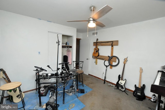 playroom featuring carpet floors, a ceiling fan, visible vents, and baseboards