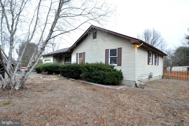 view of property exterior featuring fence