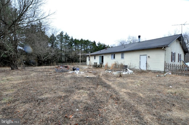 rear view of property with fence