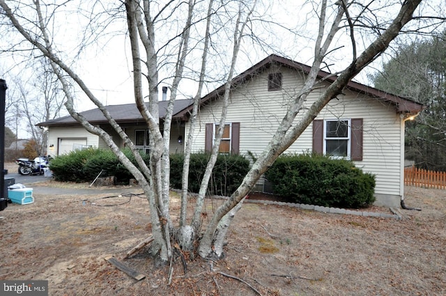 view of front of house featuring fence and an attached garage