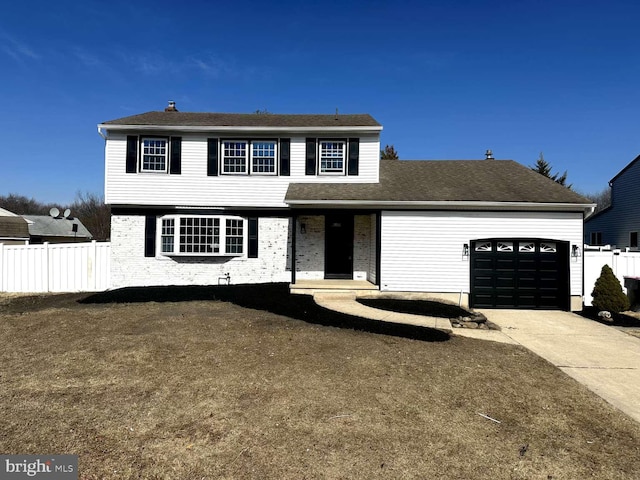 view of front facade with concrete driveway, an attached garage, and fence