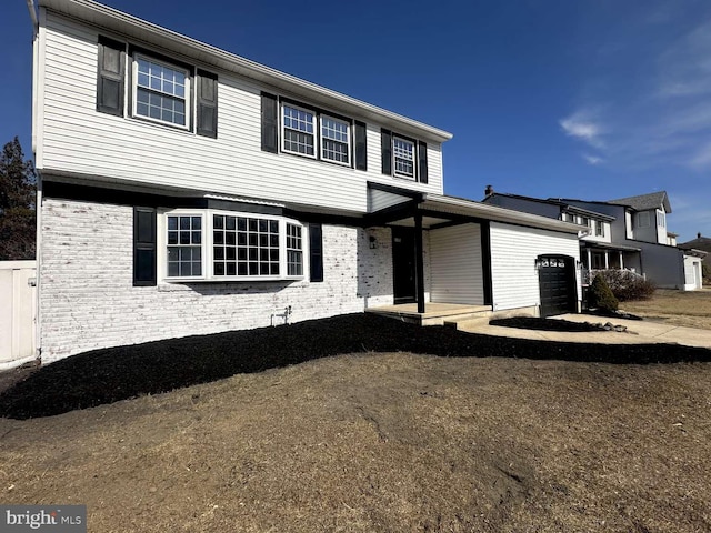 view of front of home with brick siding and an attached garage