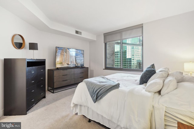 bedroom with light carpet and visible vents