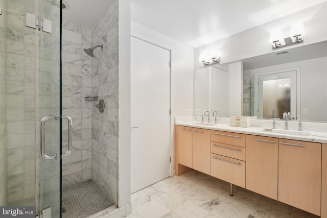 full bathroom featuring a sink, a shower stall, and double vanity