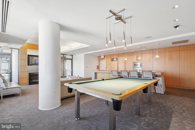 recreation room with a large fireplace, pool table, a sink, carpet flooring, and visible vents