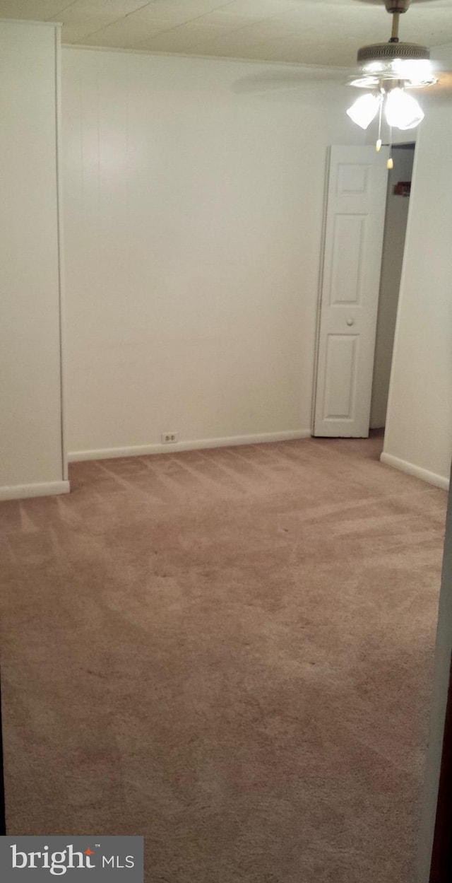 empty room with baseboards and light colored carpet