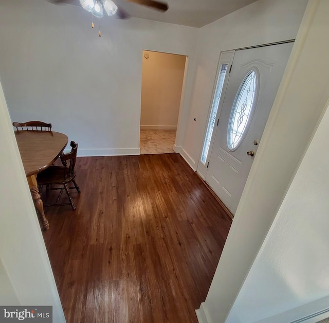 foyer with baseboards and wood finished floors