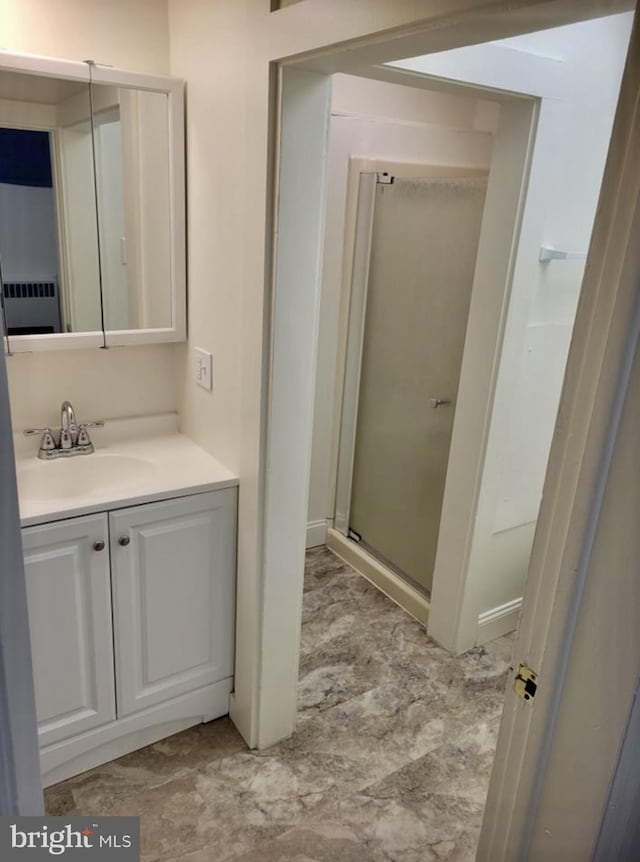 full bath with a stall shower and vanity