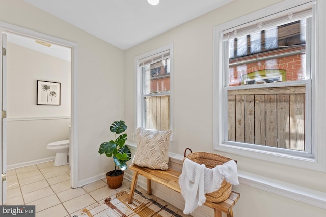 sitting room with tile patterned flooring, visible vents, and baseboards