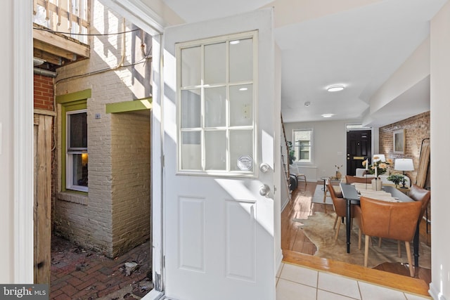 interior space featuring brick wall and tile patterned floors