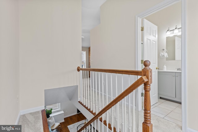 staircase featuring baseboards