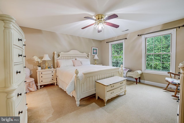 bedroom with light carpet, multiple windows, and visible vents